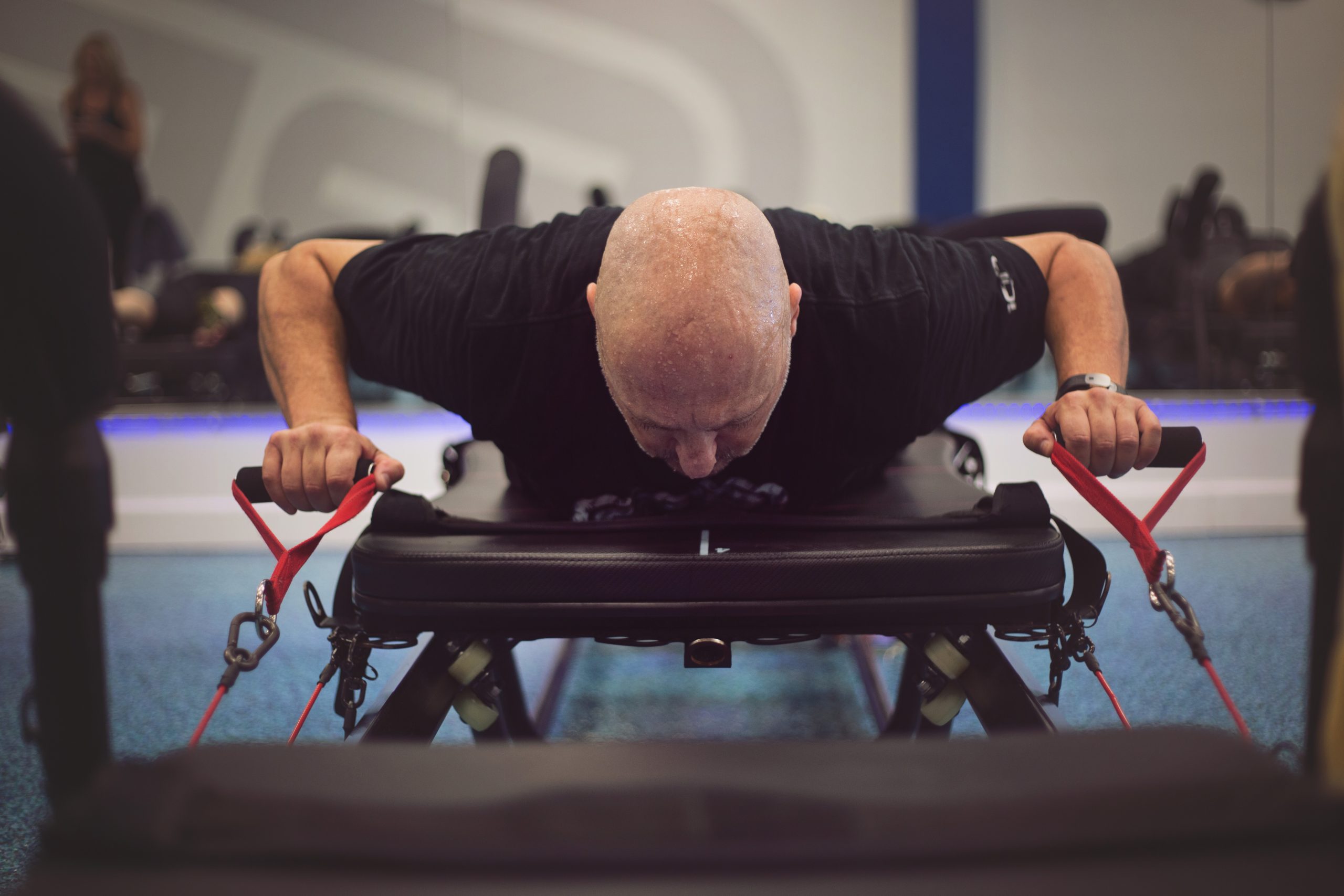 man working out on megaformer machine